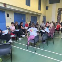 Group of teachers sat down in a school hall