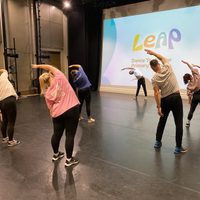Group of dancers on stage stretching