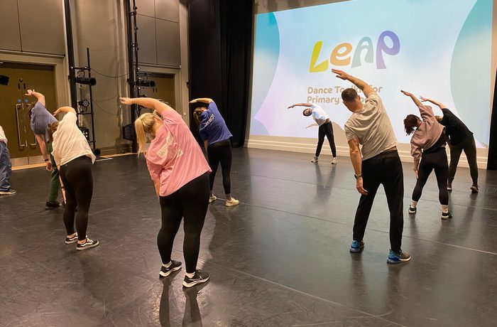 Group of dancers on stage stretching