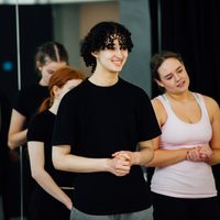 Two dancers looking out to an unknown person