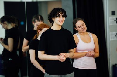 Two dancers looking out to an unknown person