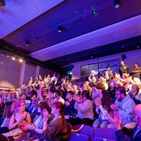 Audience applauding in a full theatre