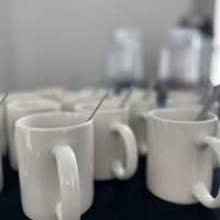 Mugs with teaspoons in them