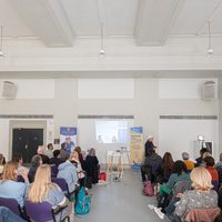 Conference Delegates facing a projection screen