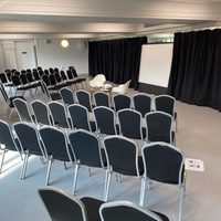 Seats facing a projection screen in a dance studio