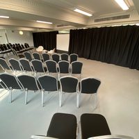 Seats facing a projection screen in a dance studio