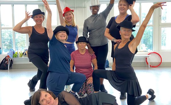 A group of people with bowler hats posing for the camera