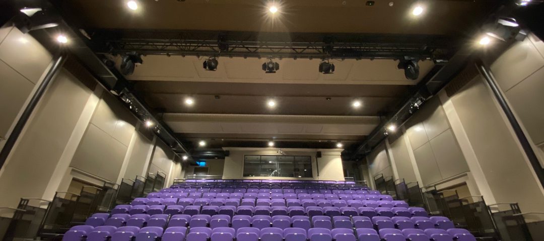 On the stage looking out at purple theatre seats