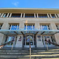 Building with front steps and several windows and a sliding front door