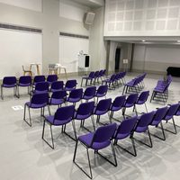 The Seafront Studio empty and laid out for an event with purple chairs