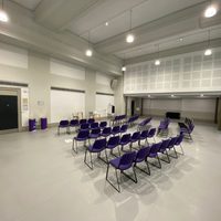 An empty dance studio set out with purple chairs