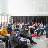 Delegates facing a person speaking in the Seafront Studio