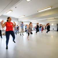 Large group of people in the middle of a dance class