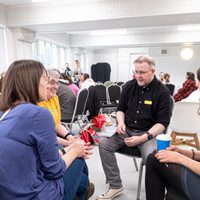 Three conference delegates sat in a dance studio